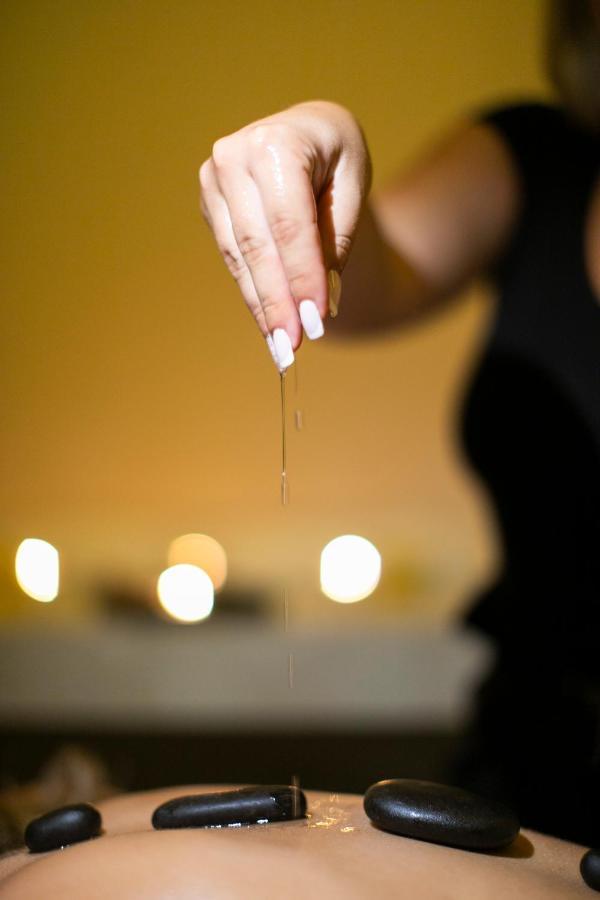Alia Palace Hotel - Adults Only 16+ Chalkidiki ภายนอก รูปภาพ A woman dripping oil on her hands