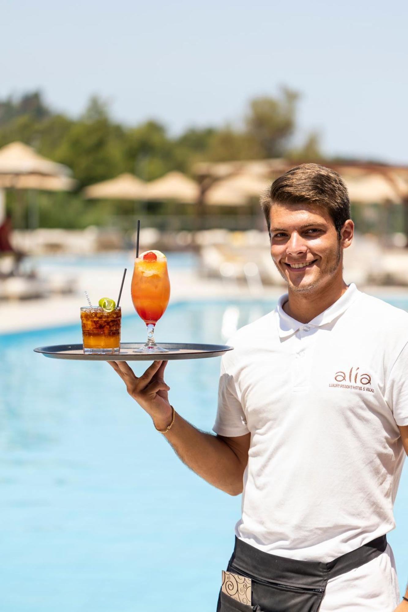Alia Palace Hotel - Adults Only 16+ Chalkidiki ภายนอก รูปภาพ A waiter serving drinks